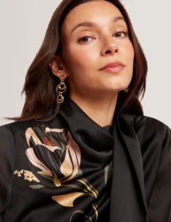 Bluse mit nouveau-wirbelartigem Bindekragen und langen Ärmeln